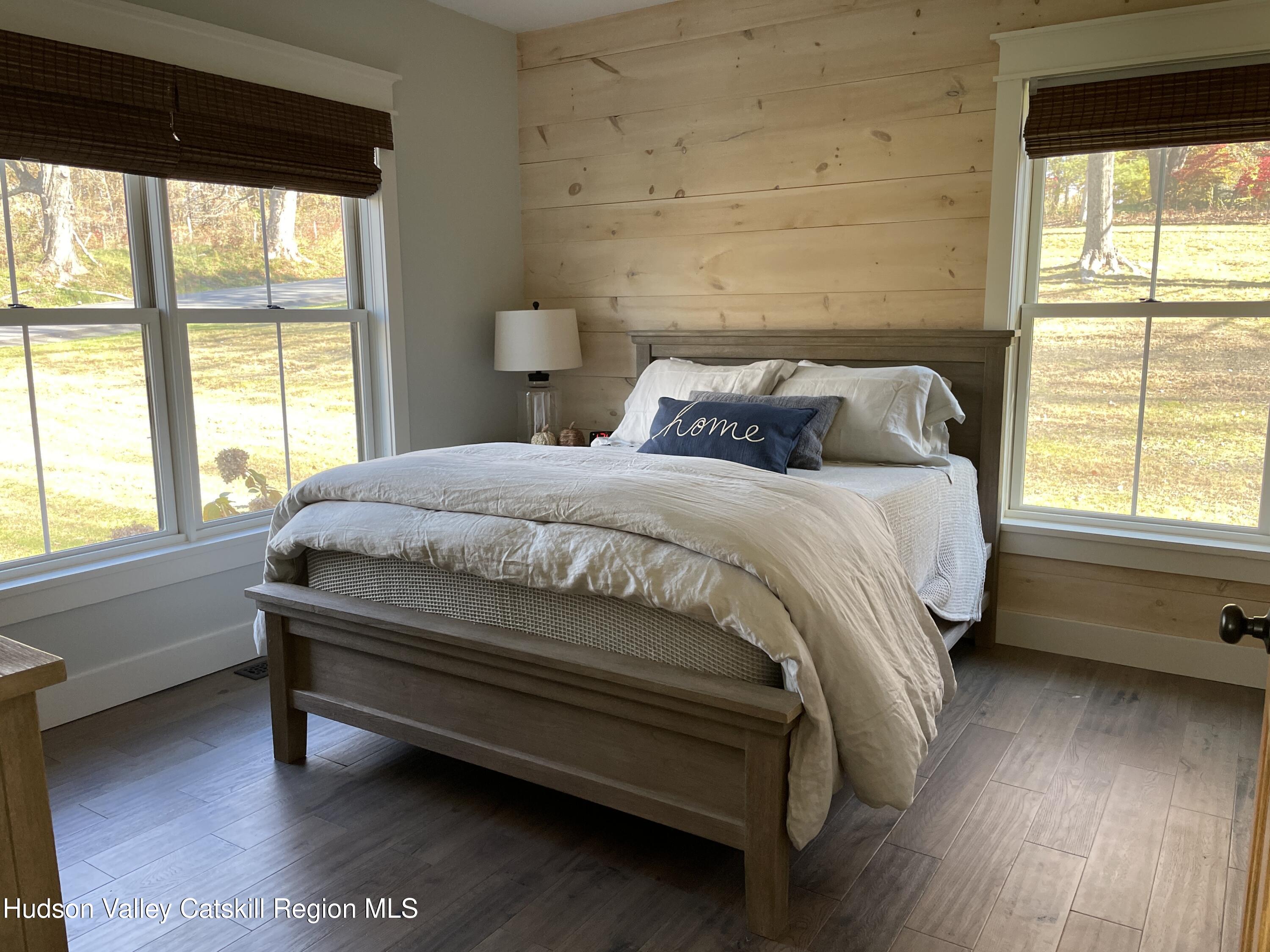 106 Beilke Road Millerton, NY 12546 - Photo 8 of 10 a bedroom with a bed and a large window