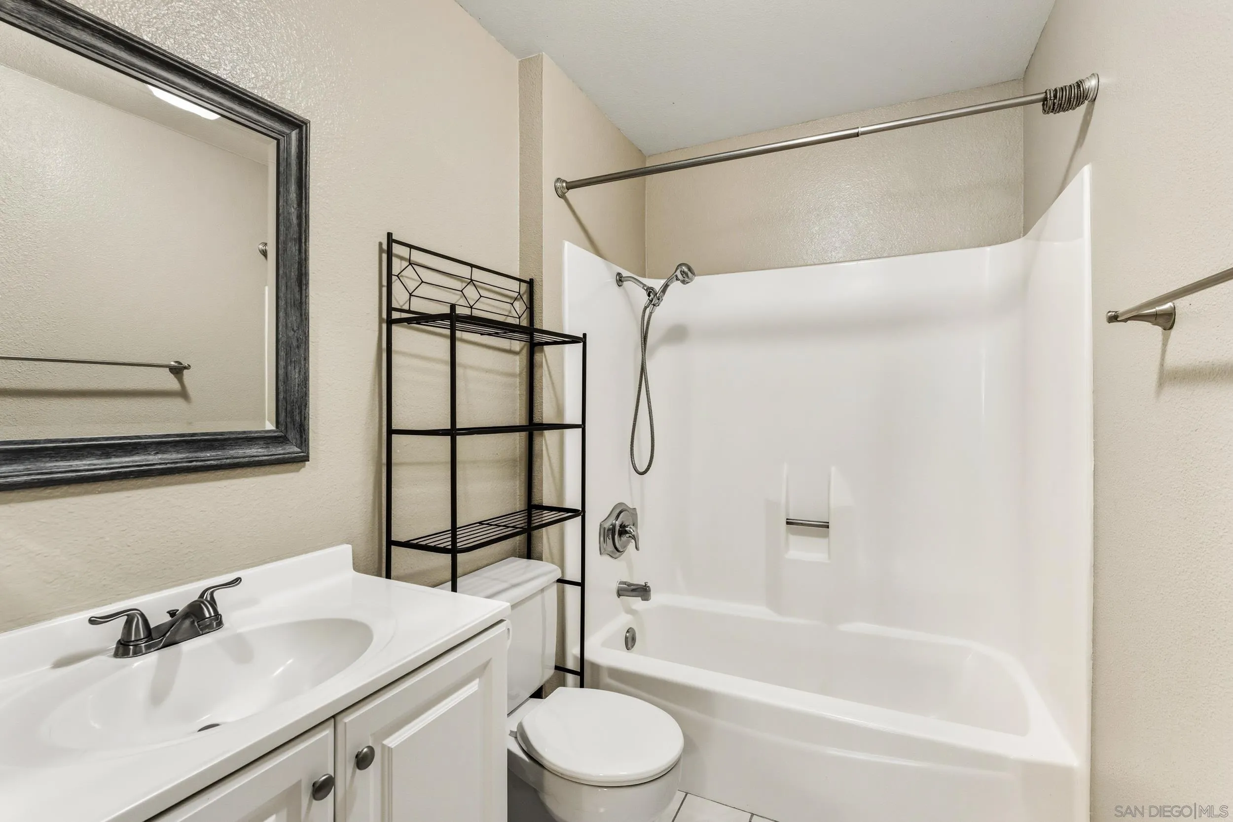 6255 Rancho Mission Road, Unit 217 San Diego, CA 92108 - Photo 14 of 23 a bathroom with a sink toilet and shower