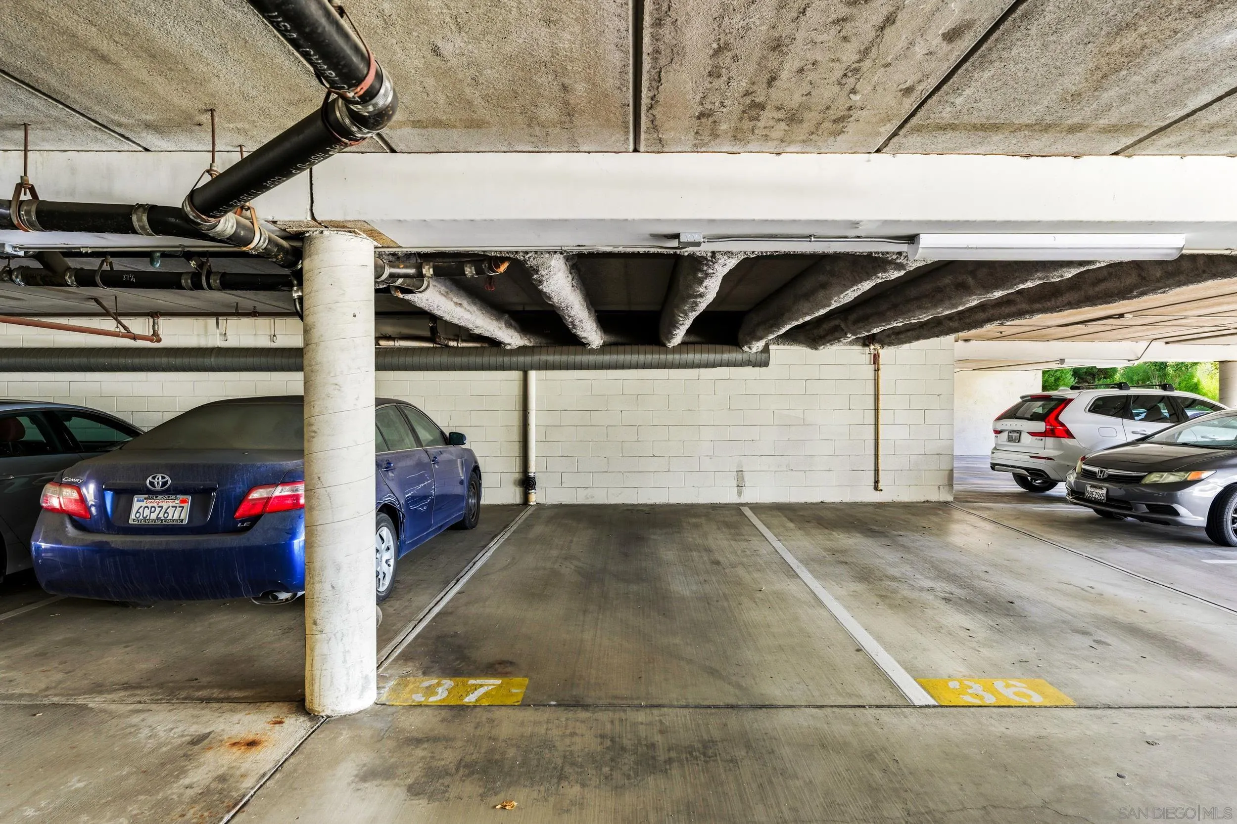 6255 Rancho Mission Road, Unit 217 San Diego, CA 92108 - Photo 17 of 23 a view of parking garage with cars