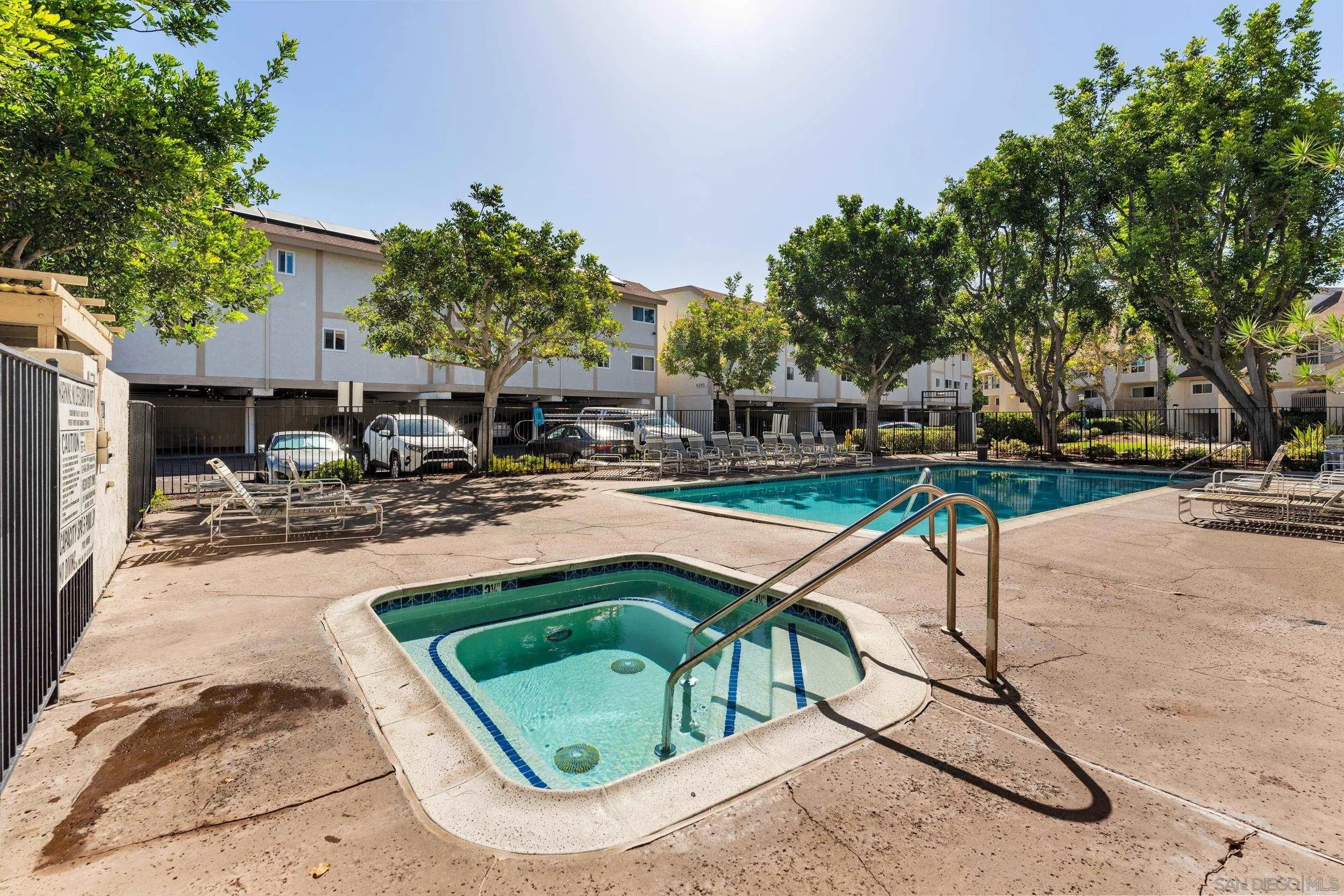 6255 Rancho Mission Road, Unit 217 San Diego, CA 92108 - Photo 19 of 23 a swimming pool with outdoor seating and yard