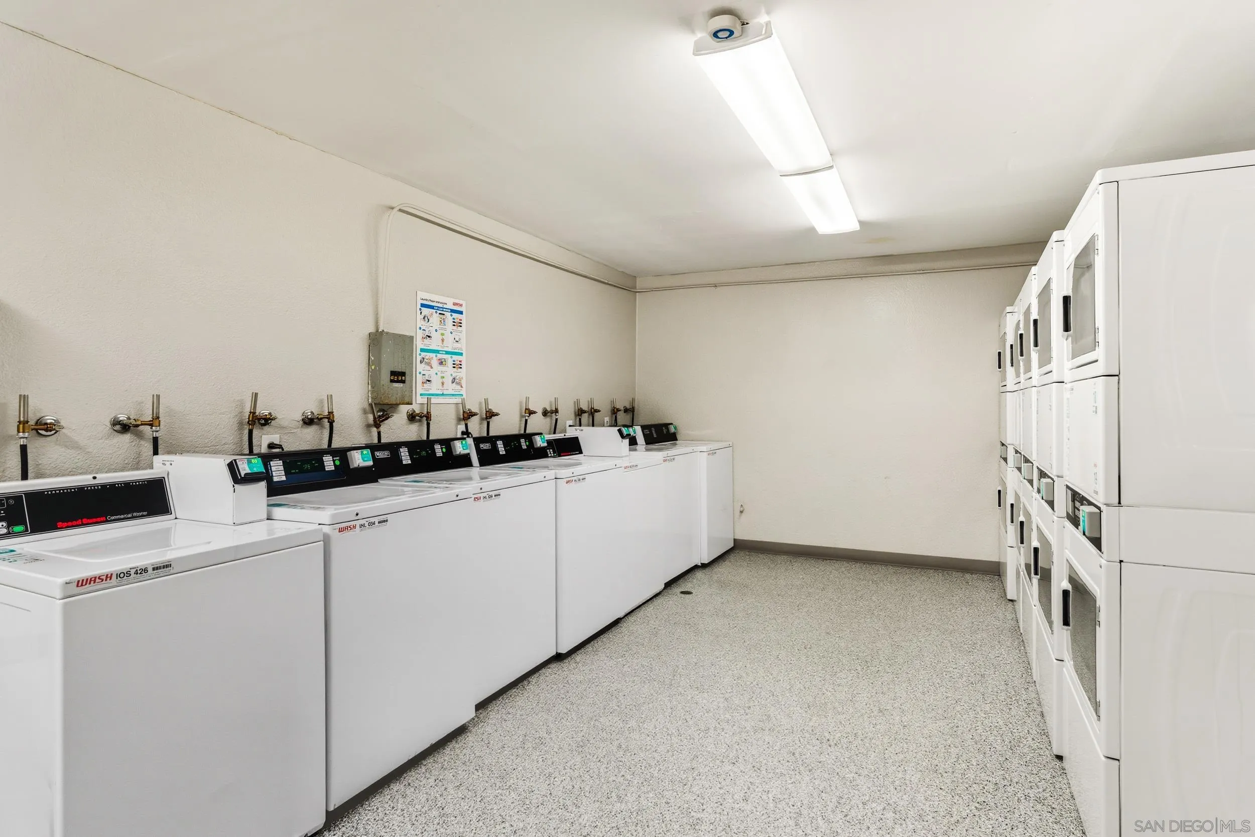 6255 Rancho Mission Road, Unit 217 San Diego, CA 92108 - Photo 22 of 23 a kitchen with cabinets and white appliances