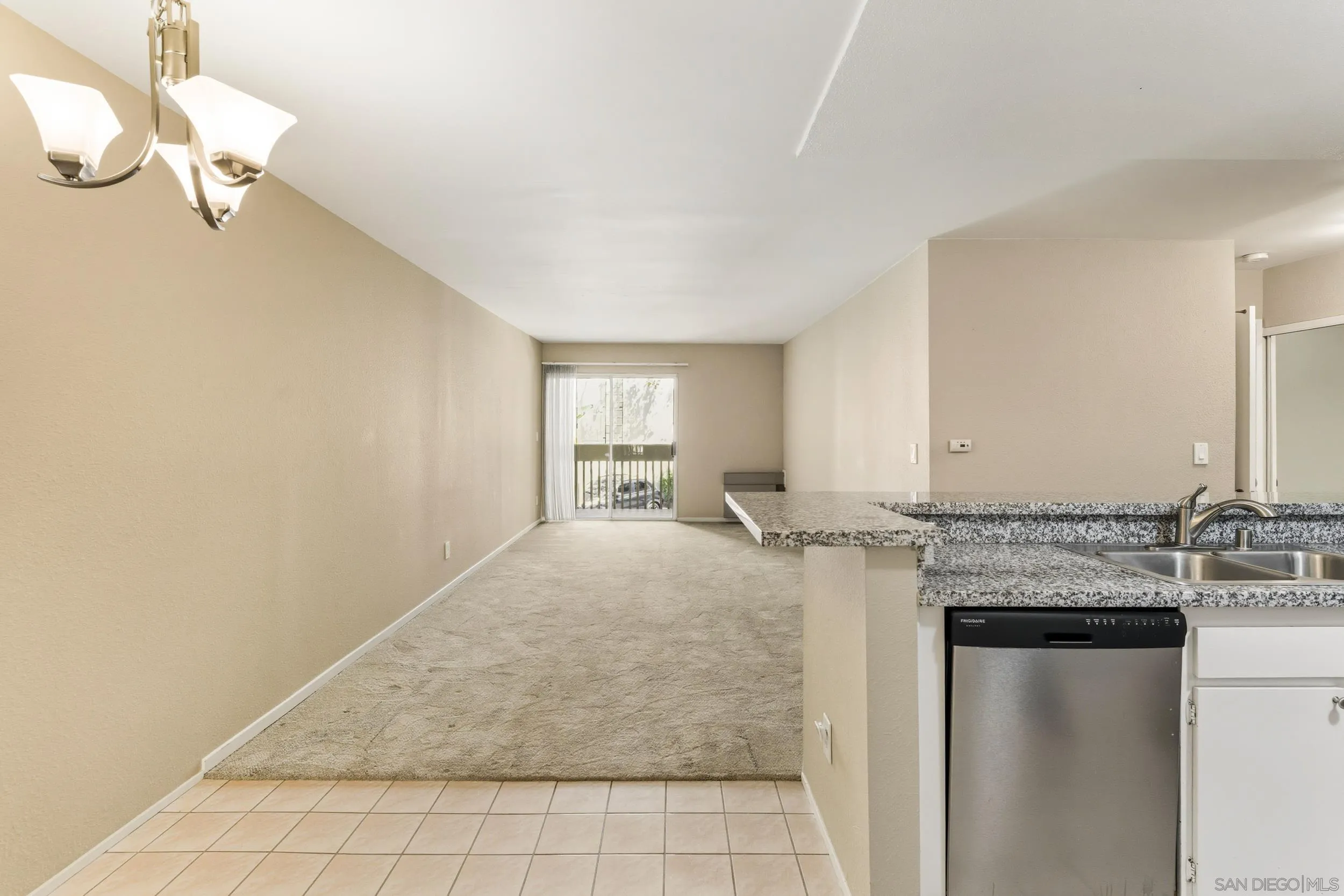 6255 Rancho Mission Road, Unit 217 San Diego, CA 92108 - Photo 4 of 23 a kitchen with granite countertop a sink cabinets and appliances