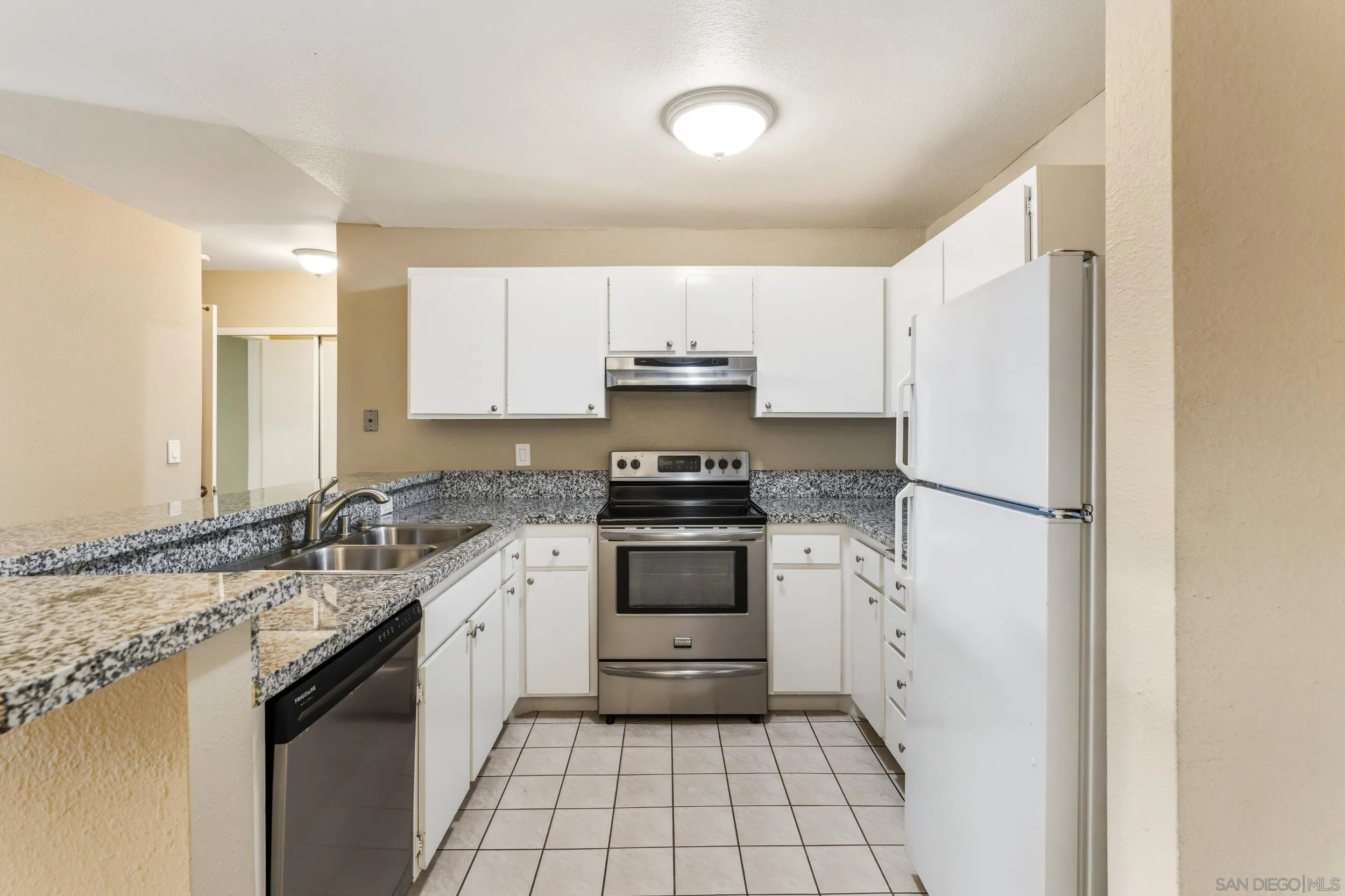 6255 Rancho Mission Road, Unit 217 San Diego, CA 92108 - Photo 8 of 23 a kitchen with a sink stove and refrigerator