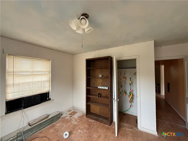 a view of room with closet and mirror