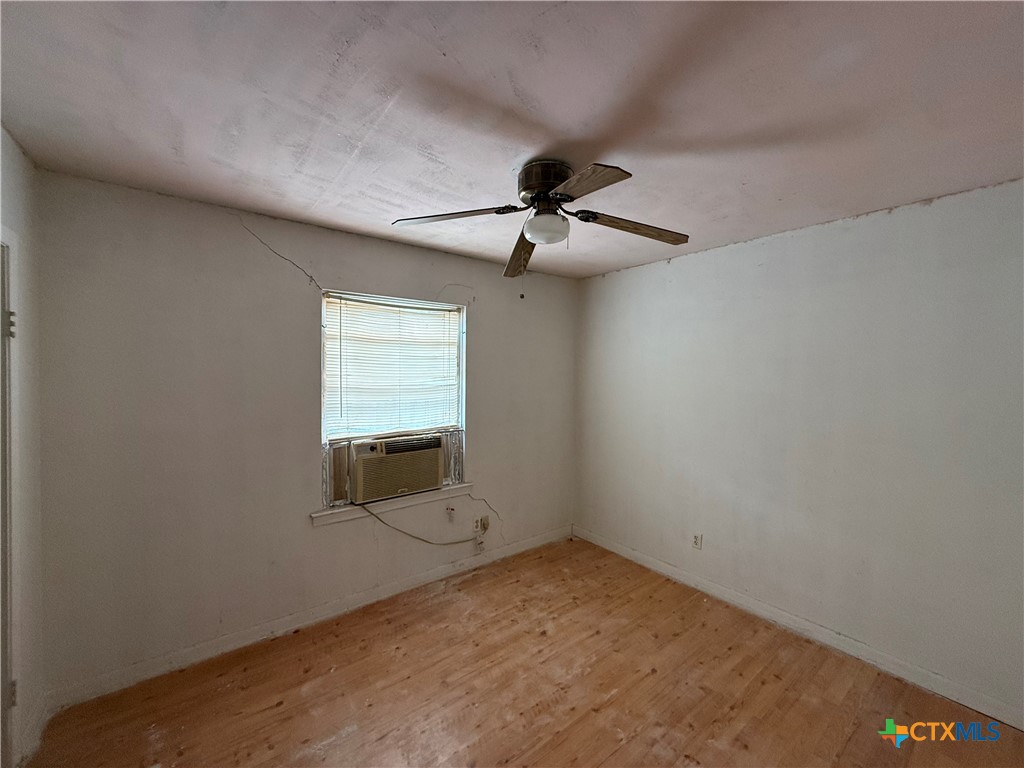 119 Runnels Street Port Lavaca, TX 77979 - Photo 13 of 18 an empty room with a ceiling fan and carpet