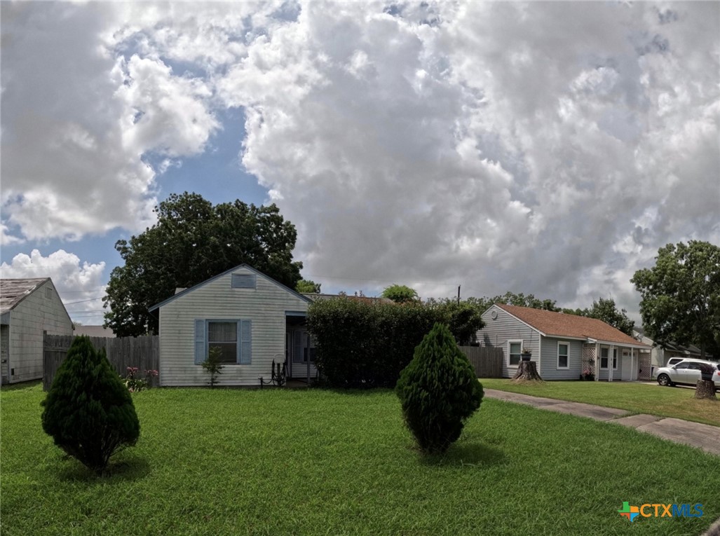 119 Runnels Street Port Lavaca, TX 77979 - Photo 2 of 18 a front view of a house with a garden