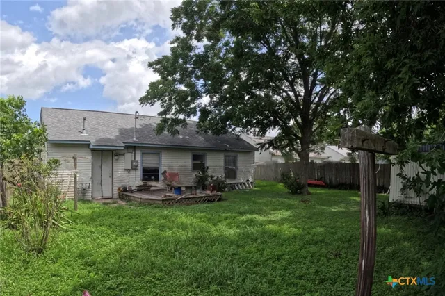 a view of a house with a yard porch and sitting area