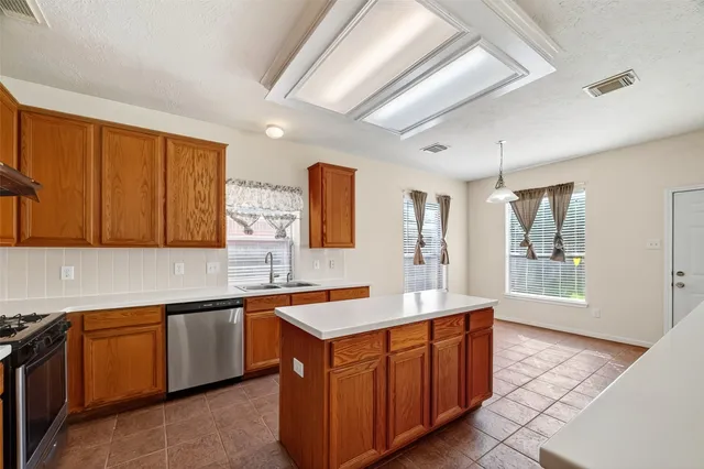 a kitchen with wooden cabinets and sink