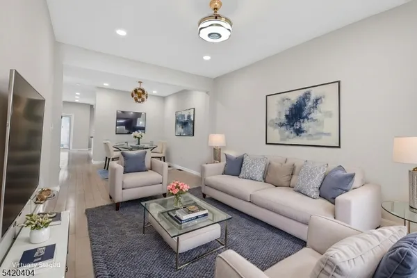 a living room with furniture a rug and a chandelier