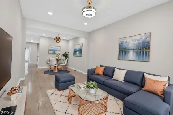 a living room with furniture and wooden floor