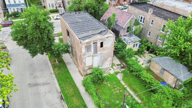 an aerial view of a house with a yard