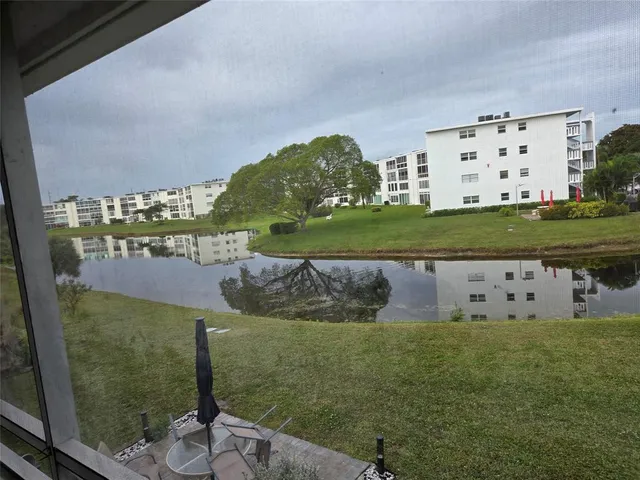a view of kitchen with a sink cabinets and wooden floor