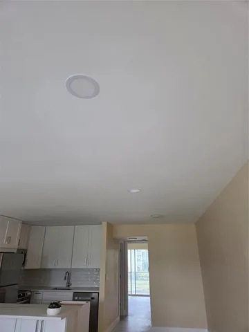 a view of a fountain in front of a house with a yard