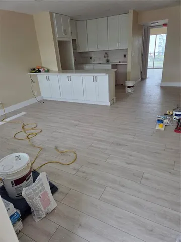 a view of tennis court with lots of trees in the background