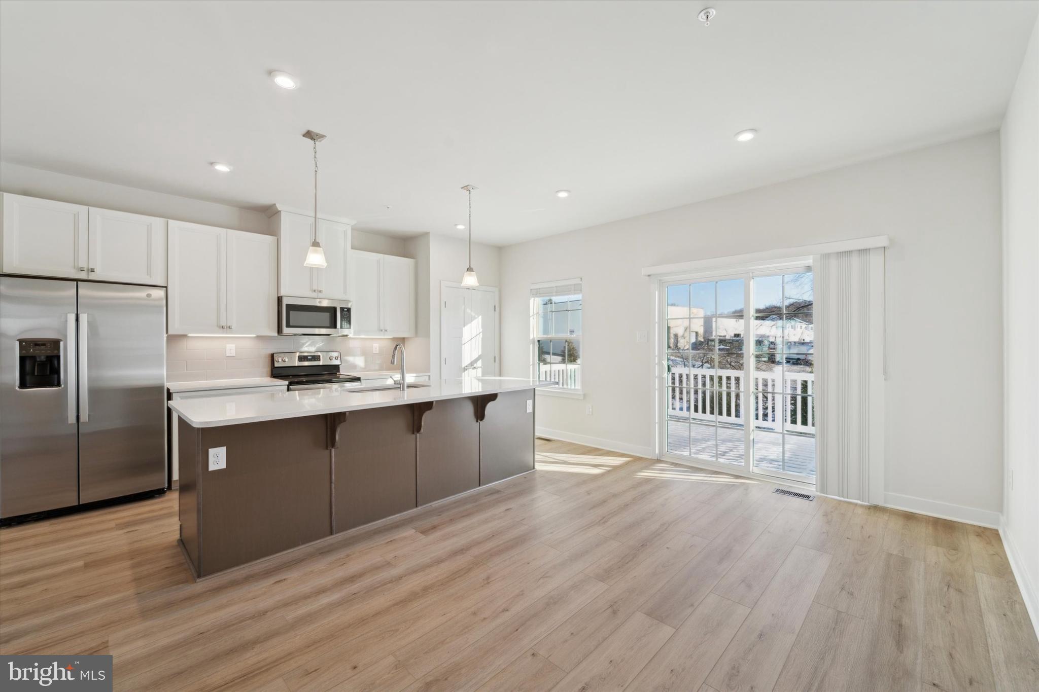 208 River Birch Way Exton, PA 19341 - Photo 11 of 25 a kitchen with stainless steel appliances granite countertop a refrigerator a sink dishwasher a stove and white cabinets with wooden floor