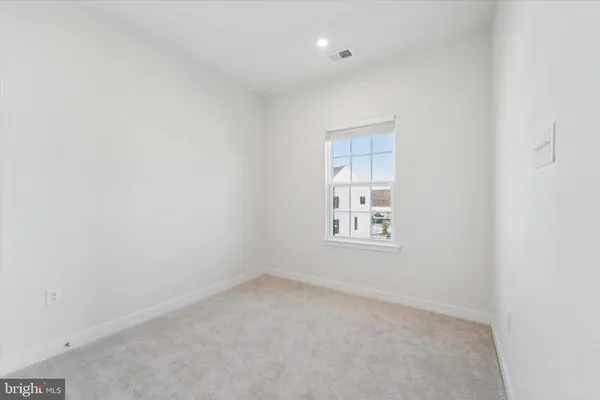a bathroom with a toilet a sink a mirror and shower