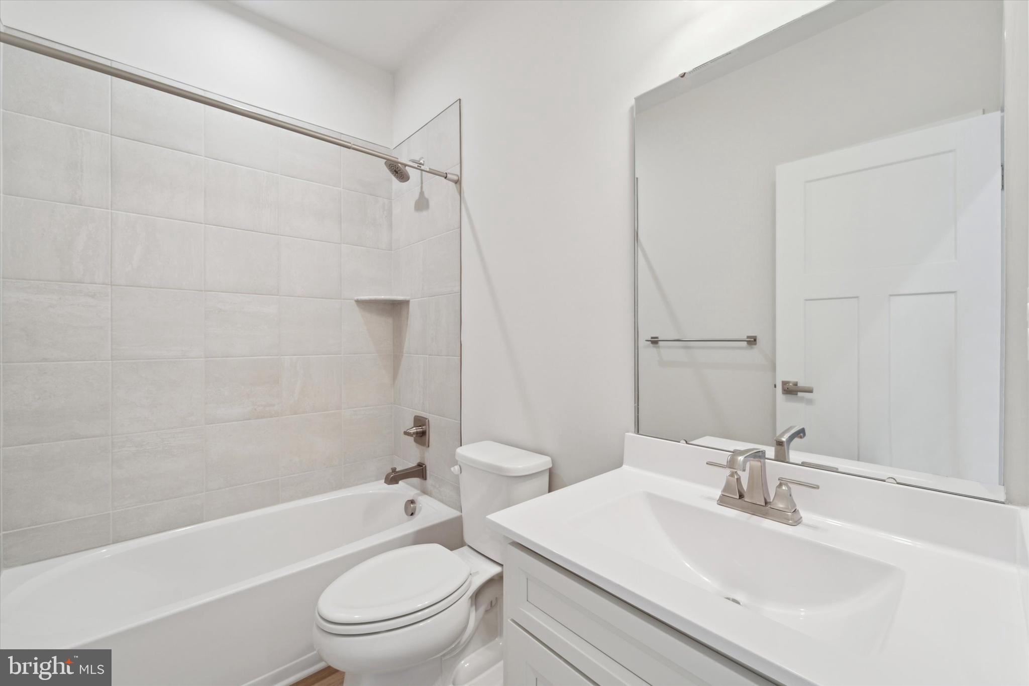 208 River Birch Way Exton, PA 19341 - Photo 21 of 25 a bathroom with a toilet a sink a mirror and shower