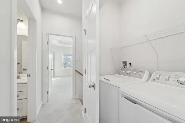 a view of a white building among the street with palm trees