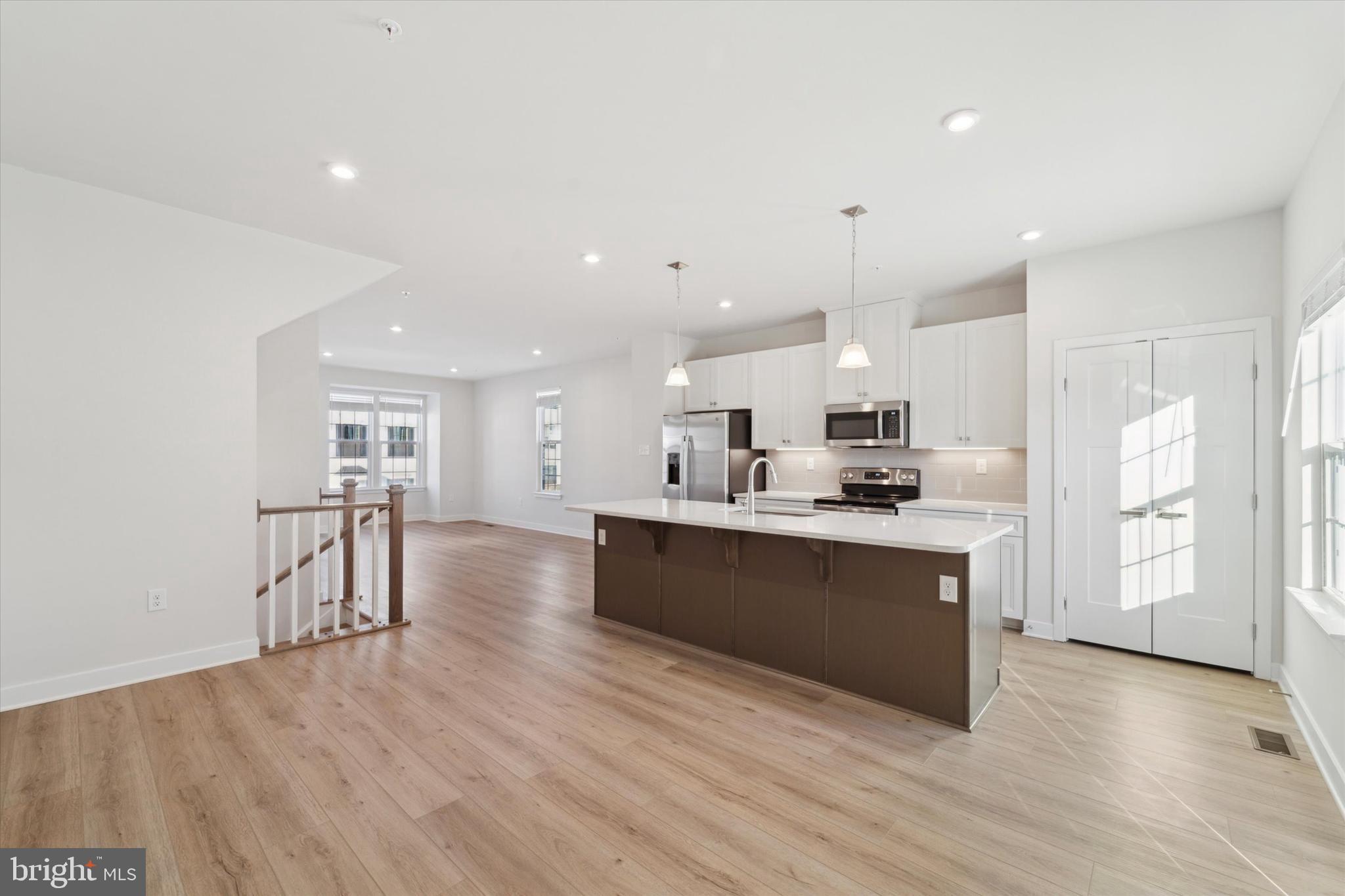 208 River Birch Way Exton, PA 19341 - Photo 10 of 25 a large kitchen with stainless steel appliances kitchen island a large counter top and a refrigerator