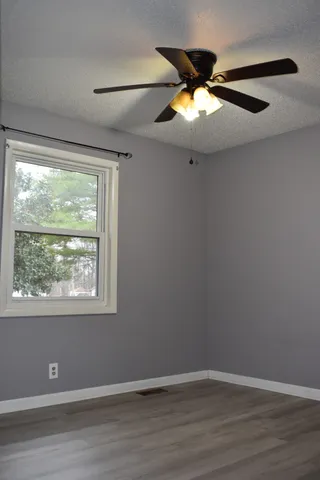 a kitchen with stainless steel appliances granite countertop a sink a stove a refrigerator and cabinets