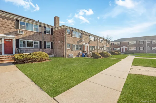 a view of a big building with a big yard and potted plants