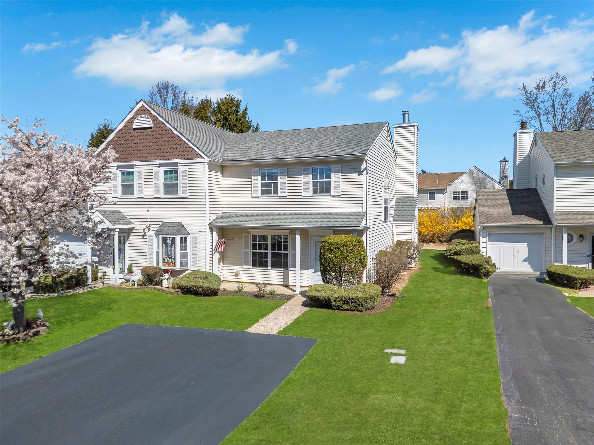 a front view of house with yard and green space