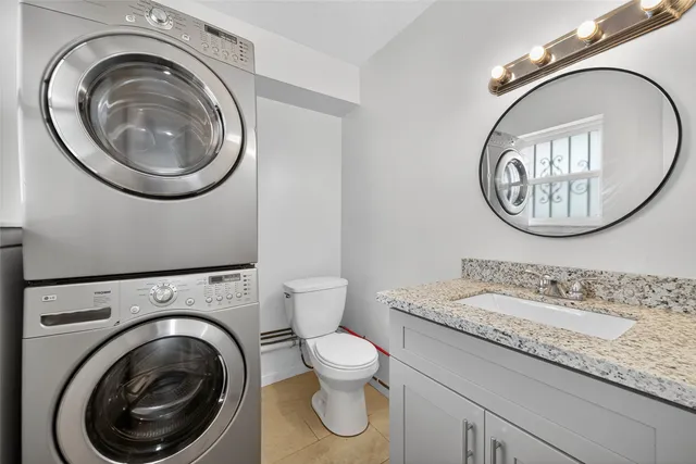 a bathroom with a sink toilet and mirror
