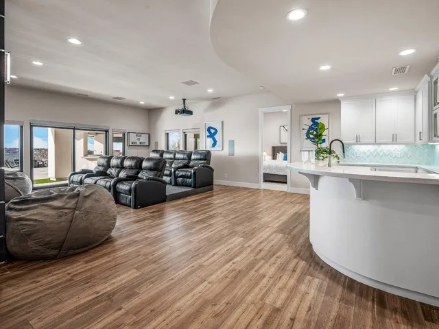 a living room with furniture and a floor to ceiling window
