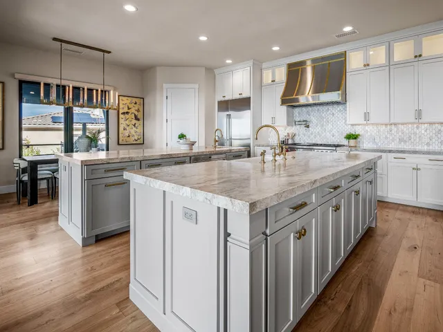 a kitchen with stainless steel appliances granite countertop a sink and a refrigerator