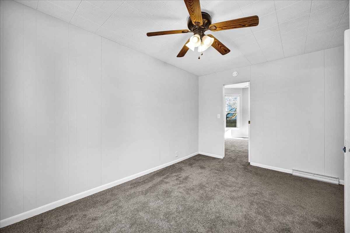 340 East Baker Street Bloomington, IL 61701 - Photo 12 of 28 an empty room with a chandelier fan and windows