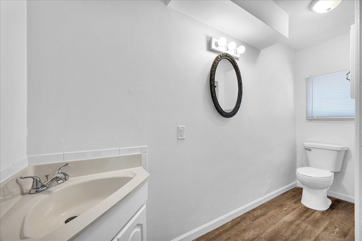 340 East Baker Street Bloomington, IL 61701 - Photo 13 of 28 a bathroom with a sink a toilet and a mirror