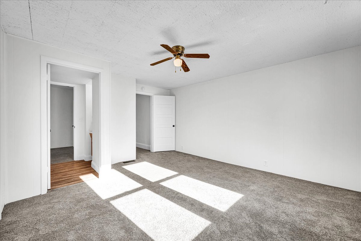 340 East Baker Street Bloomington, IL 61701 - Photo 17 of 28 an empty room with windows and ceiling fan