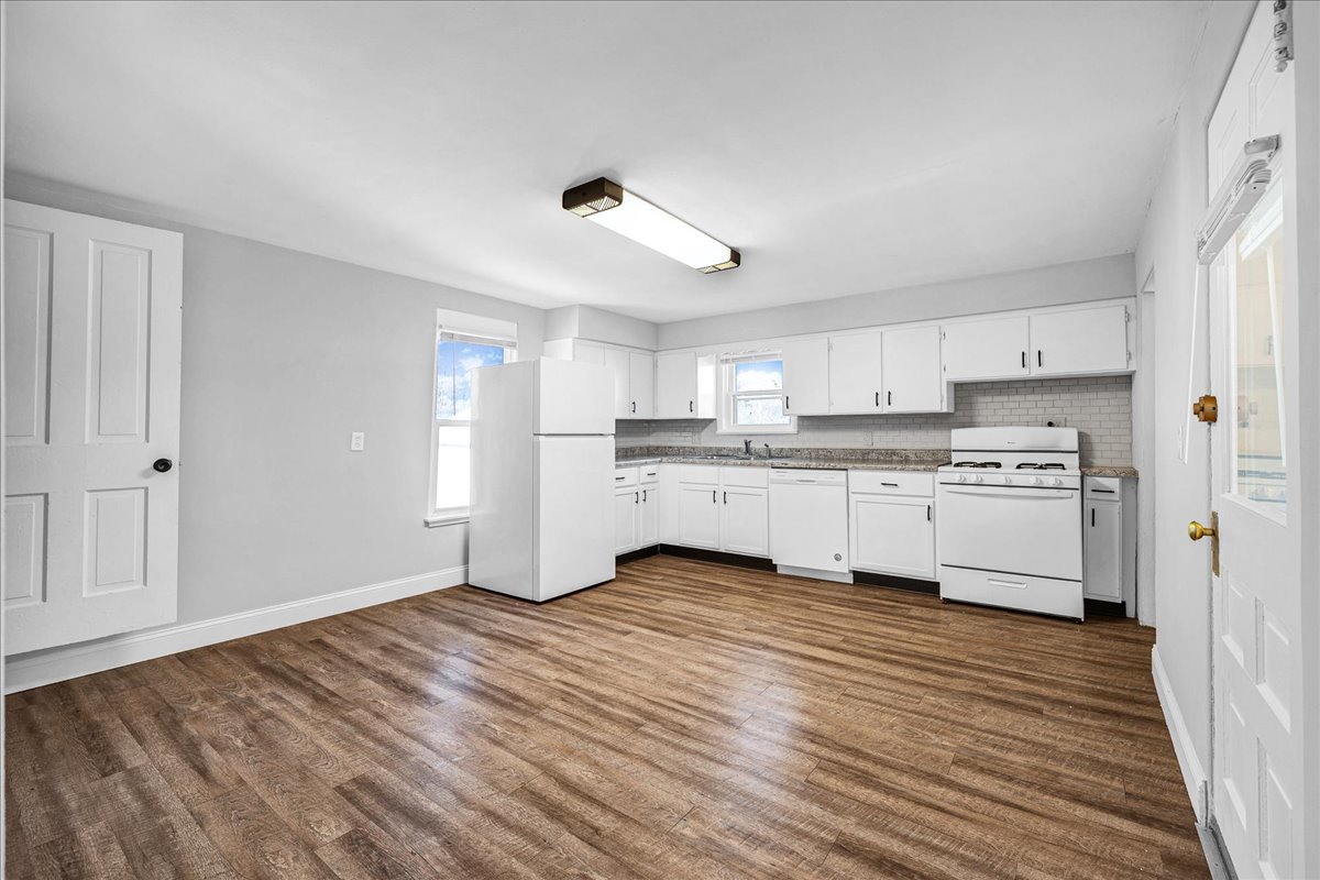 340 East Baker Street Bloomington, IL 61701 - Photo 7 of 28 a view of kitchen with wooden floor and electronic appliances