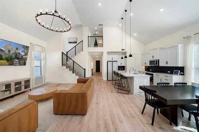 a living room with furniture and kitchen view