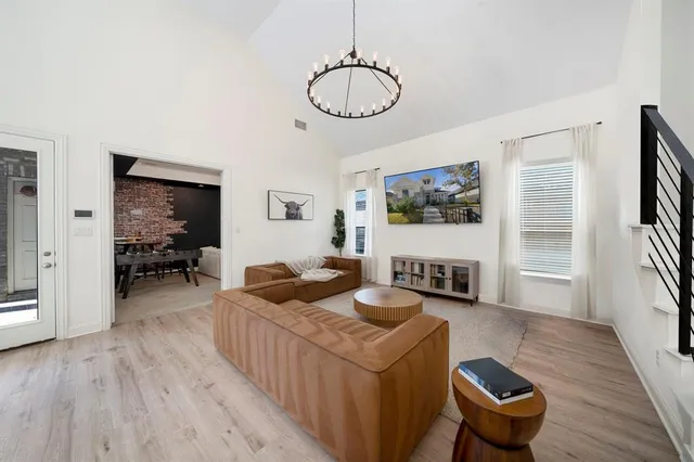 a living room with furniture a window and a flat screen tv