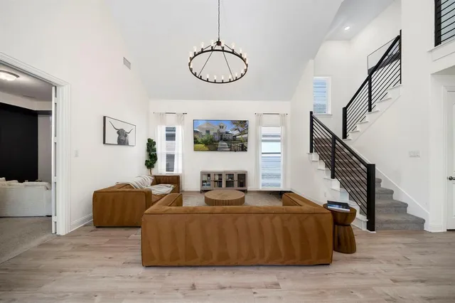 a living room with furniture windows and a chandelier
