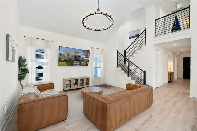 a living room with furniture and wooden floor