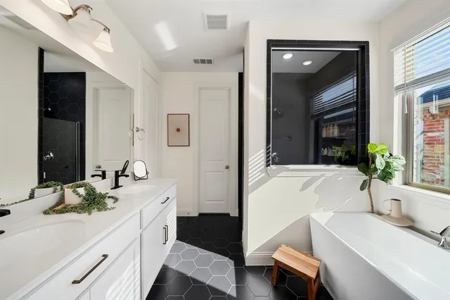 a spacious bathroom with a granite countertop tub sink and mirror