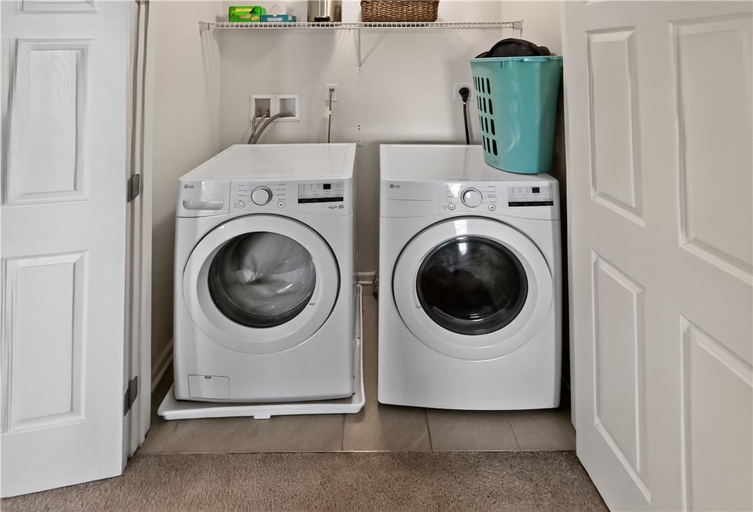 4502 Benjamin Court Emmaus, PA 18049 - Photo 38 of 48 Functional laundry nook with full-size appliances, complete with a convenient storage shelf.