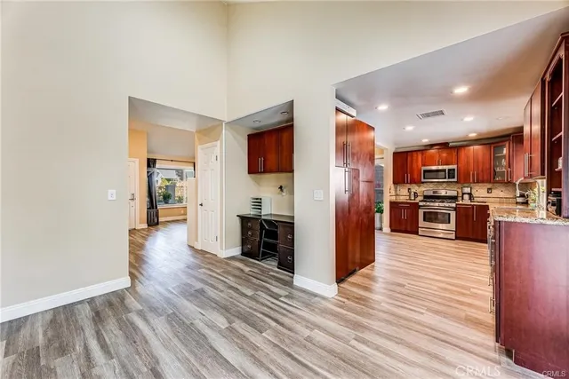 a view of kitchen with refrigerator microwave and stove