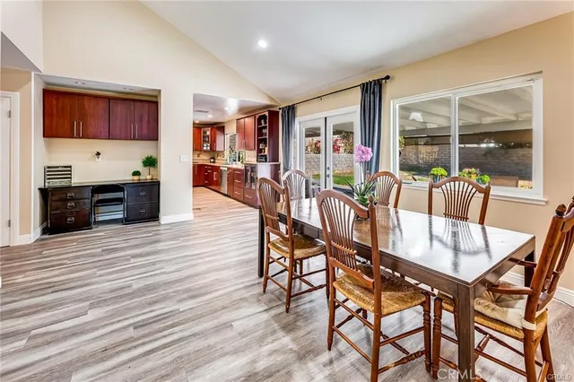 a dining room with furniture and wooden floor