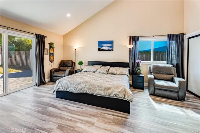 a spacious bedroom with a large bed and a large window