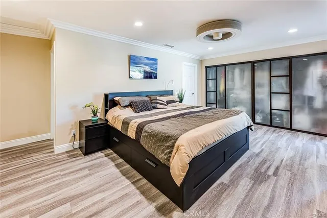 a spacious bedroom with a bed and a dresser