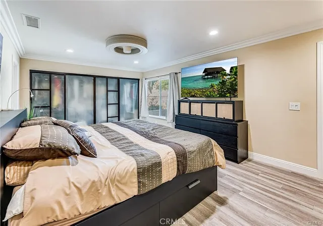 a bedroom with a large bed and a large window