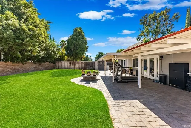 a view of a house with backyard porch and sitting area
