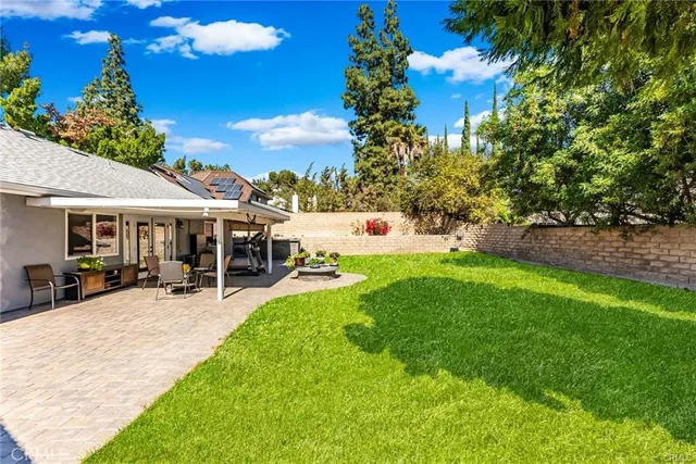 a view of a house with backyard porch and sitting area
