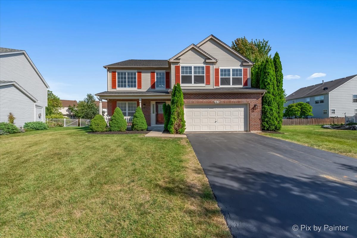 a front view of a house with a yard and garage