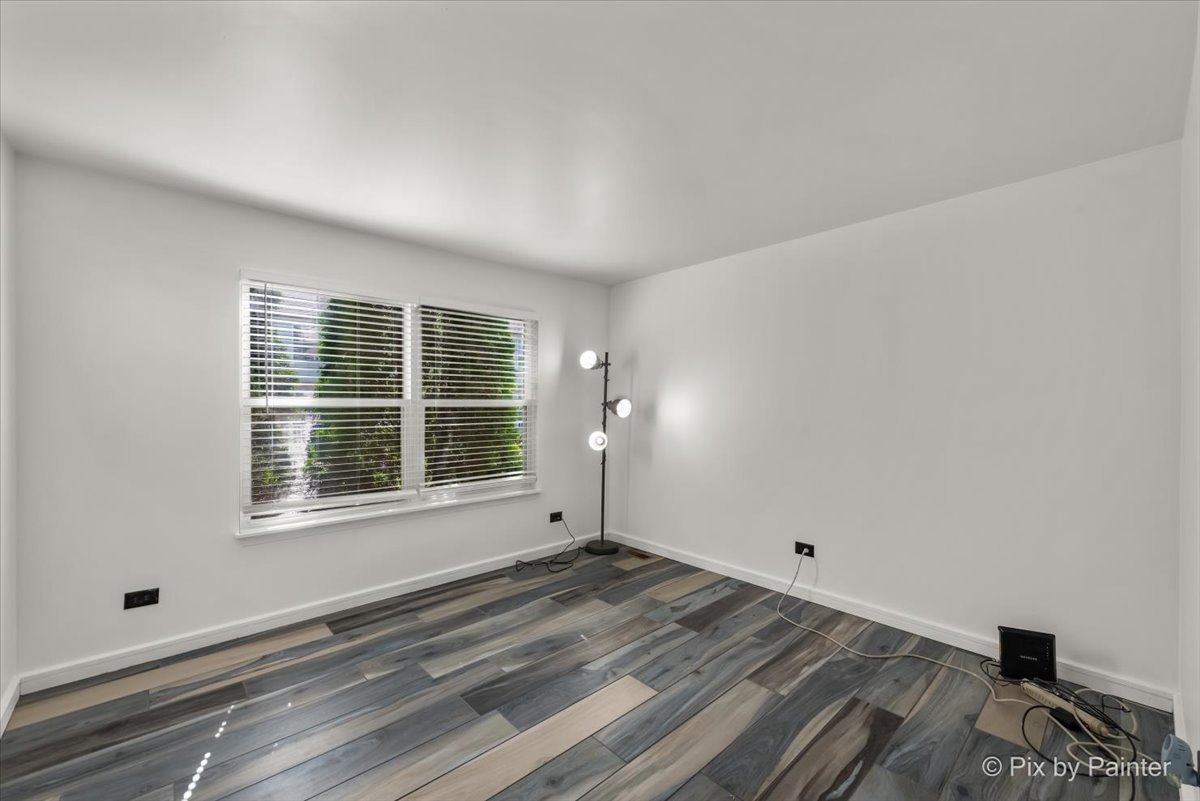 1812 Arbor Fields Drive Plainfield, IL 60586 - Photo 12 of 35 a view of empty room with wooden floor and fan