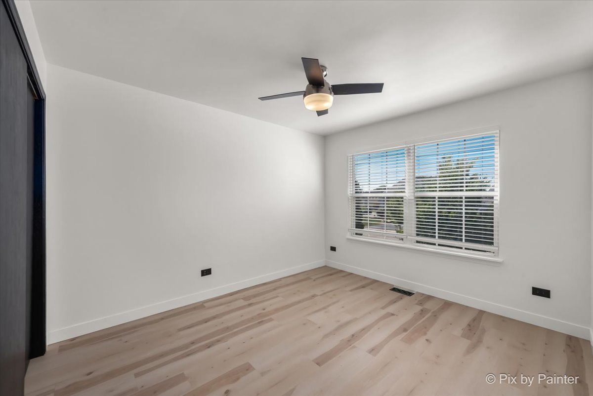 1812 Arbor Fields Drive Plainfield, IL 60586 - Photo 22 of 35 a view of an empty room with a window and wooden floor
