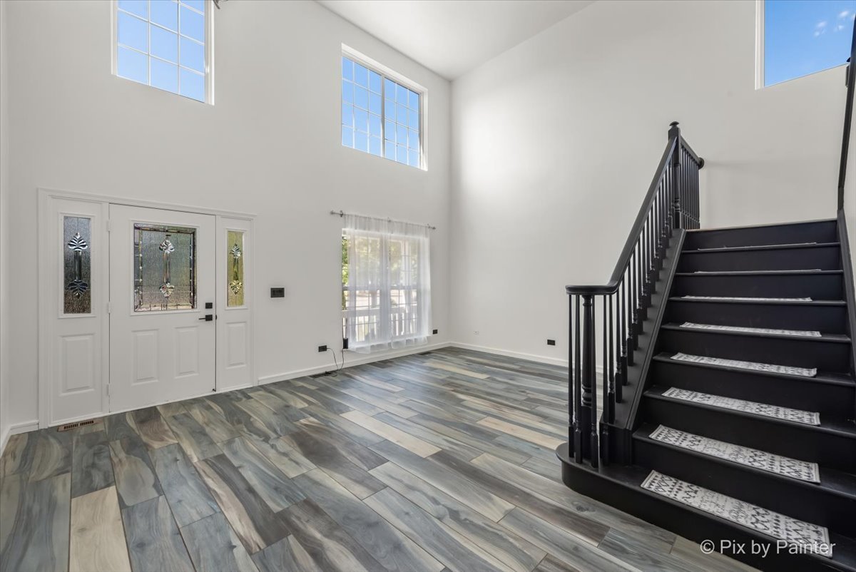 1812 Arbor Fields Drive Plainfield, IL 60586 - Photo 3 of 35 a view of an entryway with wooden floor and stairs